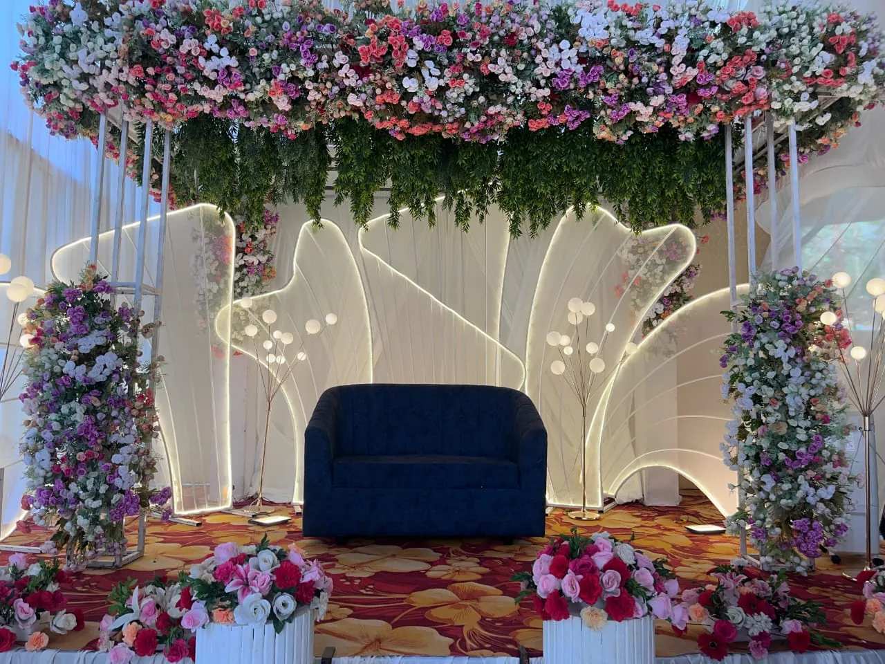 Stage under a canopy of flowers with glowing white panels
